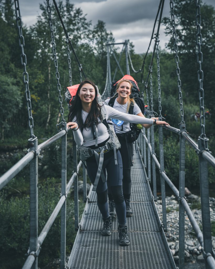 Happy hikers on a bridge, Fjällräven backpack 