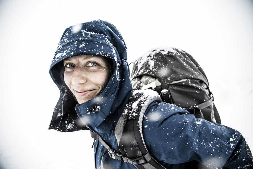 Woman hiking in the snow, Fjällräven backpack, Fjällräven shell jacket