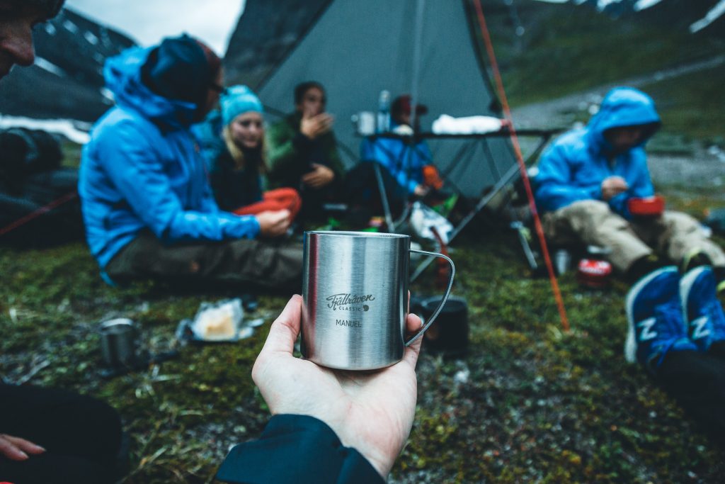 Having a cup of coffee with friends at camp