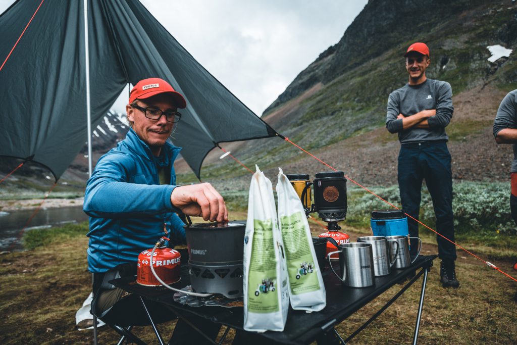 Chad brewing a cup of coffee in the outdoors