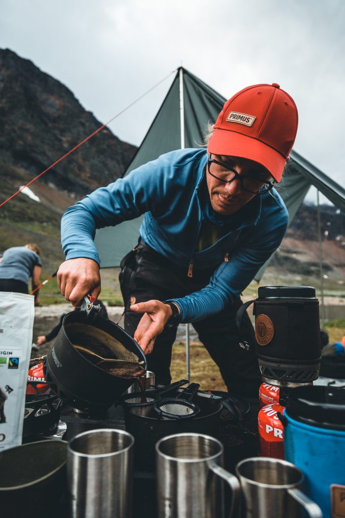 Chad brewing a cup of coffee in the outdoors
