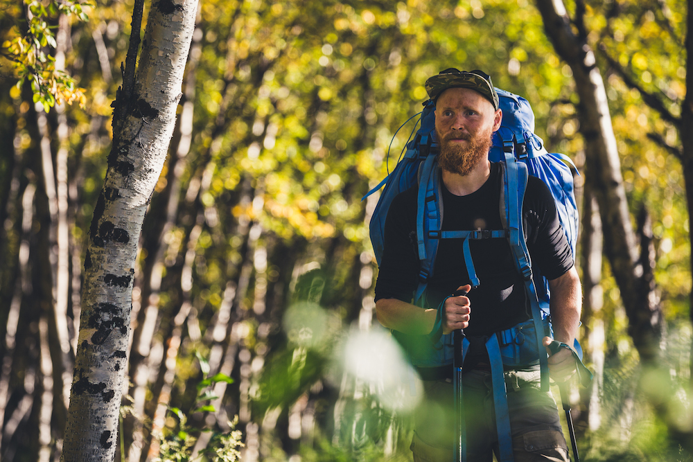 Martin Andersson hiking in the forest, fjällräven backpack