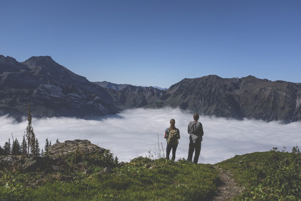 Hikers admiring the view above the clouds 